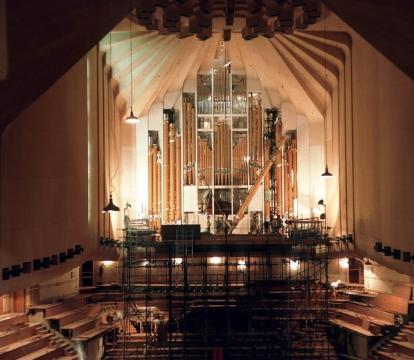 Large musical organ in a room with tall ceilings.