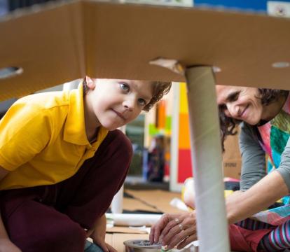 Educators and the kids playing with cardboard.