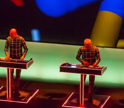Four men playing piano on the stage.
