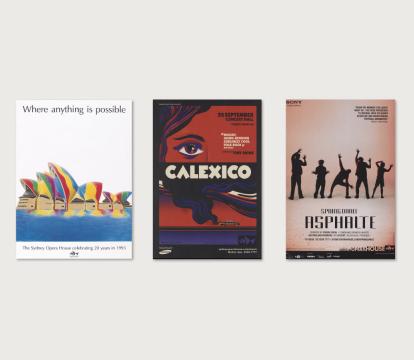 A collection of five colorful posters, framed against a white wall.