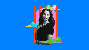 Woman in black and white with curly hair stands confidently, set against a vibrant blue background.