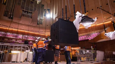 Builders lowering equipment into the Concert Hall.