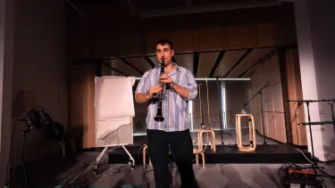 The resident artist plays the clarinet.