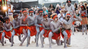Men performing indigenous dance in the homeground of Sydney opera house.
