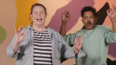 A man and a woman doing hand gestures.