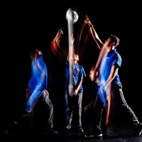 Four Liverpool High boys point at a ball moving in the air.