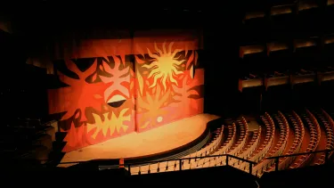 A curtain in the Concert hall with tapestry art.