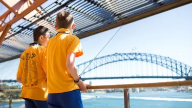 Two school boys looking at the Harbour bridge from the Sydney opera house.